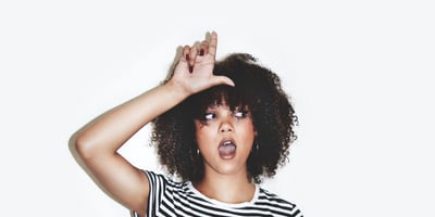 Woman Posing with Loser Hand Sign